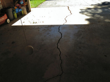 Large Crack in Concrete Garage Slab from Concrete Driveway